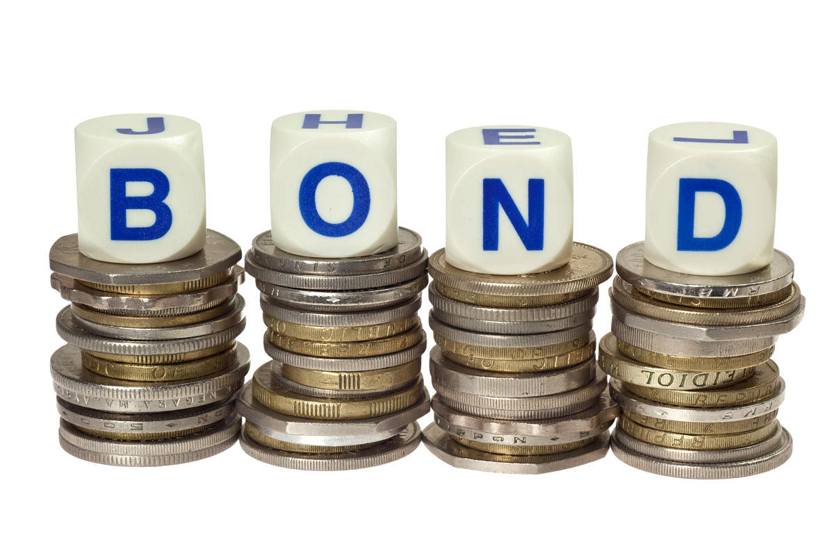 Stacks of coins with the word bond isolated on white backgroundbond
