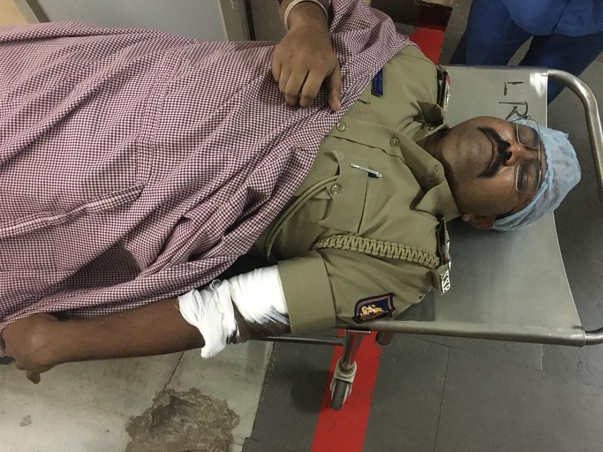A police officer and a constable were attacked by a fleeing suspect, early Monday morning, when the police team went to the suspect's house to arrest him in connection with a case registered in Vijayapura.