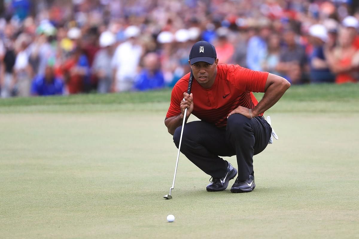 SLOWLY GETTING THERE Tiger Woods lines up a putt on the 18th green during the final round of the Valspar Championship in Palm Harbor, Florida on Sunday. AFP