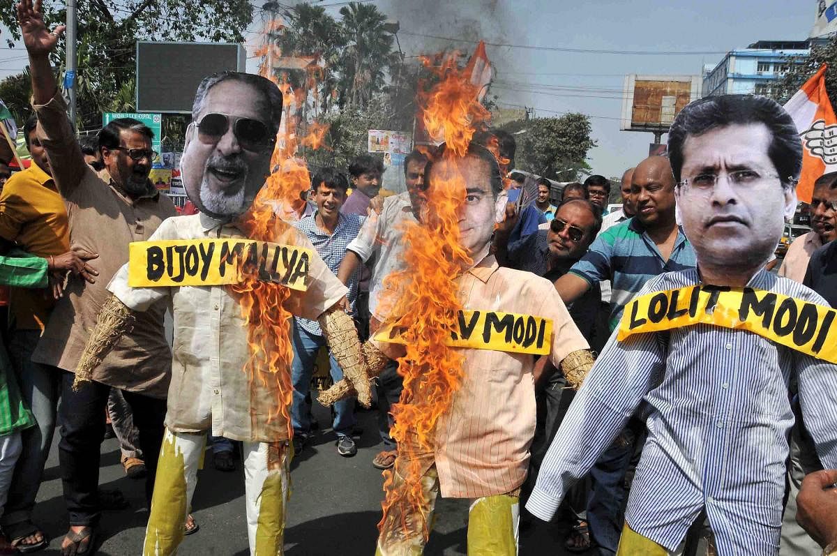 Congress activists burn effigies of Nirav Modi,Vijay Mallya and Lalit Modi during a demonstration protest in Kolkata on Sunday.PTI