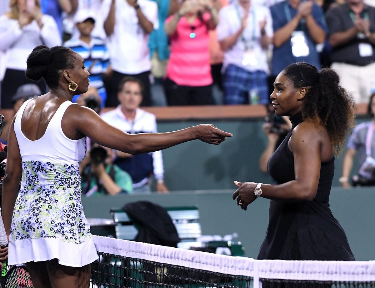 Venus Williams (left) greets Serena after her win over her sister in Indian Wells on Monday. AFP