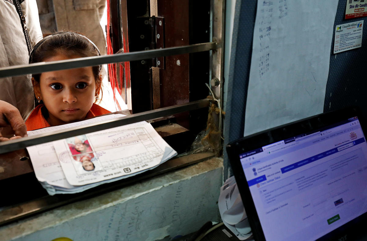 A girl waits for her turn to enrol for the Unique Identification (UID) database system, also known as Aadhaar, at a registration centre in New Delhi. Reuters file photo