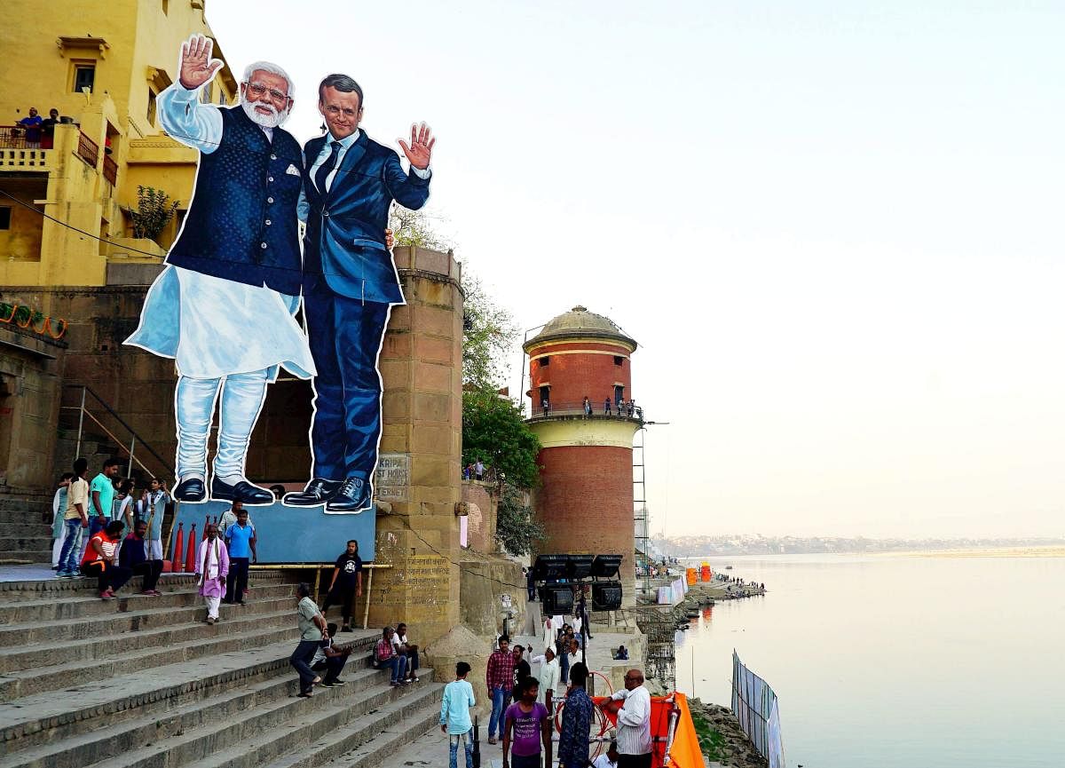 Huge cutouts of Prime Minister Narendra Modi and French President Emmanuel Macron at Tulsi Ghat ahead of their visit in Varanasi on Sunday. PTI