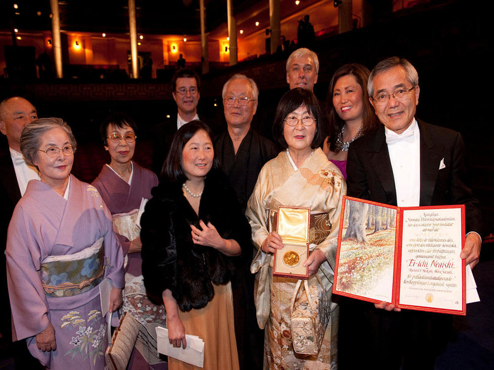 Reuters file photo of Ei-ichi Negishi (R) and his wife Sumire Negishi (2nd R) are surrounded by his family members as he displays his diploma and medal after winning the 2010 Nobel Prize in Chemistry during the award ceremony at the Concert Hall in Stockholm.