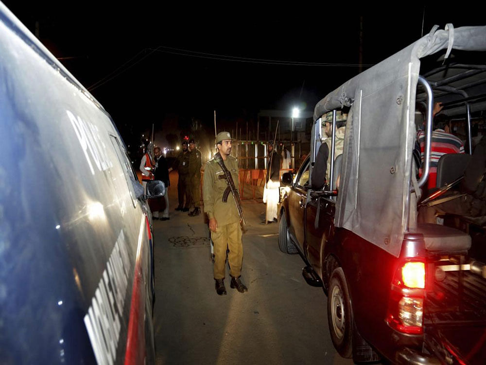 Pakistani police officers cordon off the area of a bomb blast. AP/PTI photo