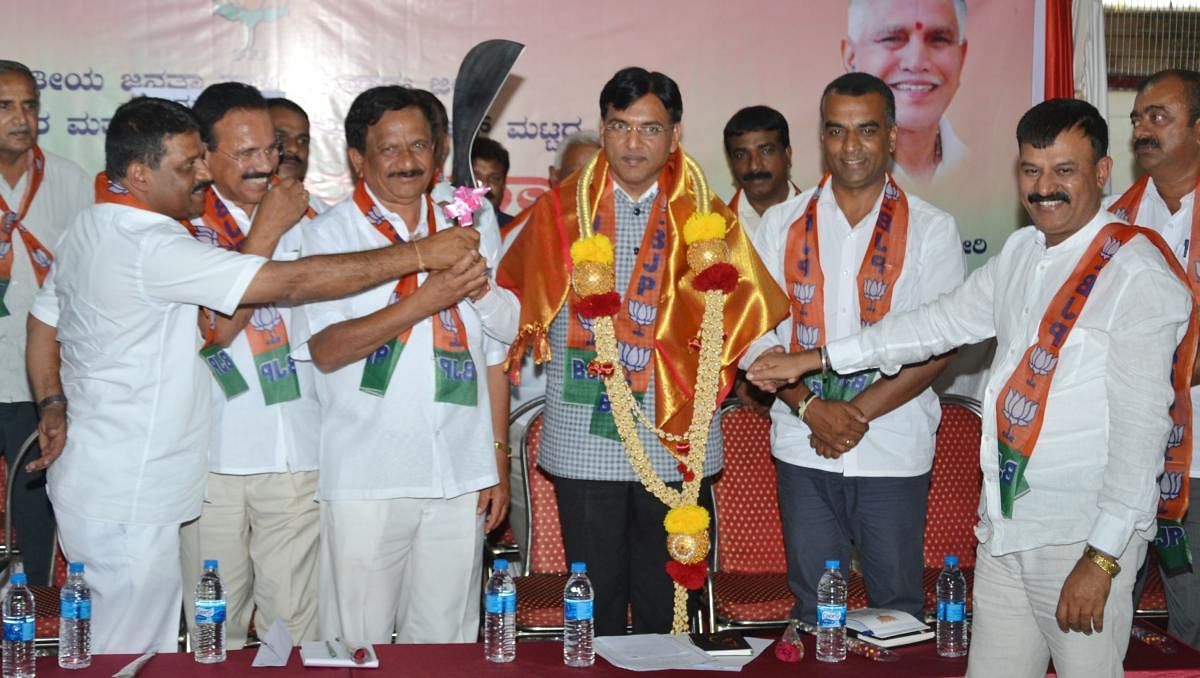 Minister of State in the Ministry of Road Transport and Highways Mansukh L Mandaviya being felicitated at BJP booth level Navashakthi convention in Madikeri on Friday.