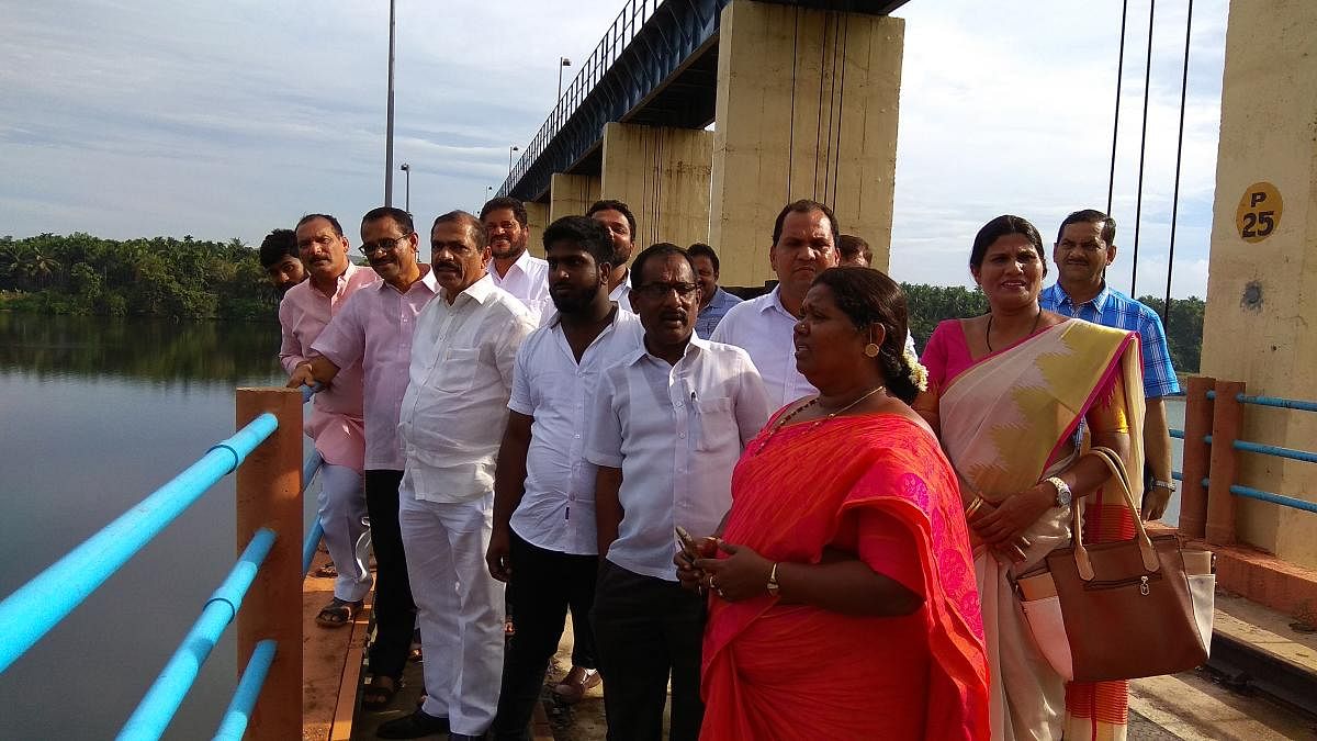 Mayor Bhaskar Moily, Chief Whip of the Government in Legislative Council Ivan D'Souza and others inspect the water level in Thumbe vented dam, on Friday.