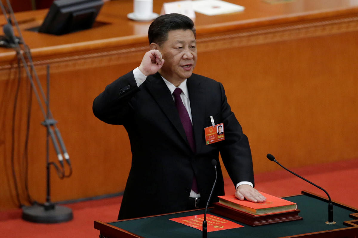 Chinese President Xi Jinping with his hand on the Constitution takes the oath, after he is voted as the president for another term, at the fifth plenary session of the National People's Congress (NPC) at the Great Hall of the People in Beijing, China March 17, 2018. Reuters photo.