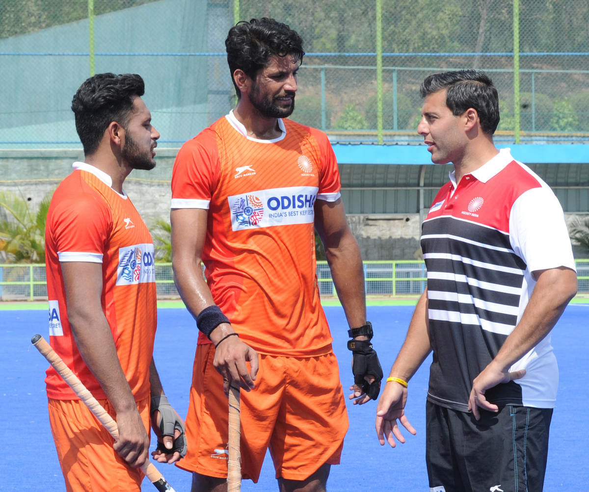 STICK TOGETHER, BOYS... Drag-flick expert Chris Ciriello (right) interacts with team Rupinderpal Singh (centre) and Harmanpreet Singh. DH PHOTO/ SRIKANTA SHARMA R