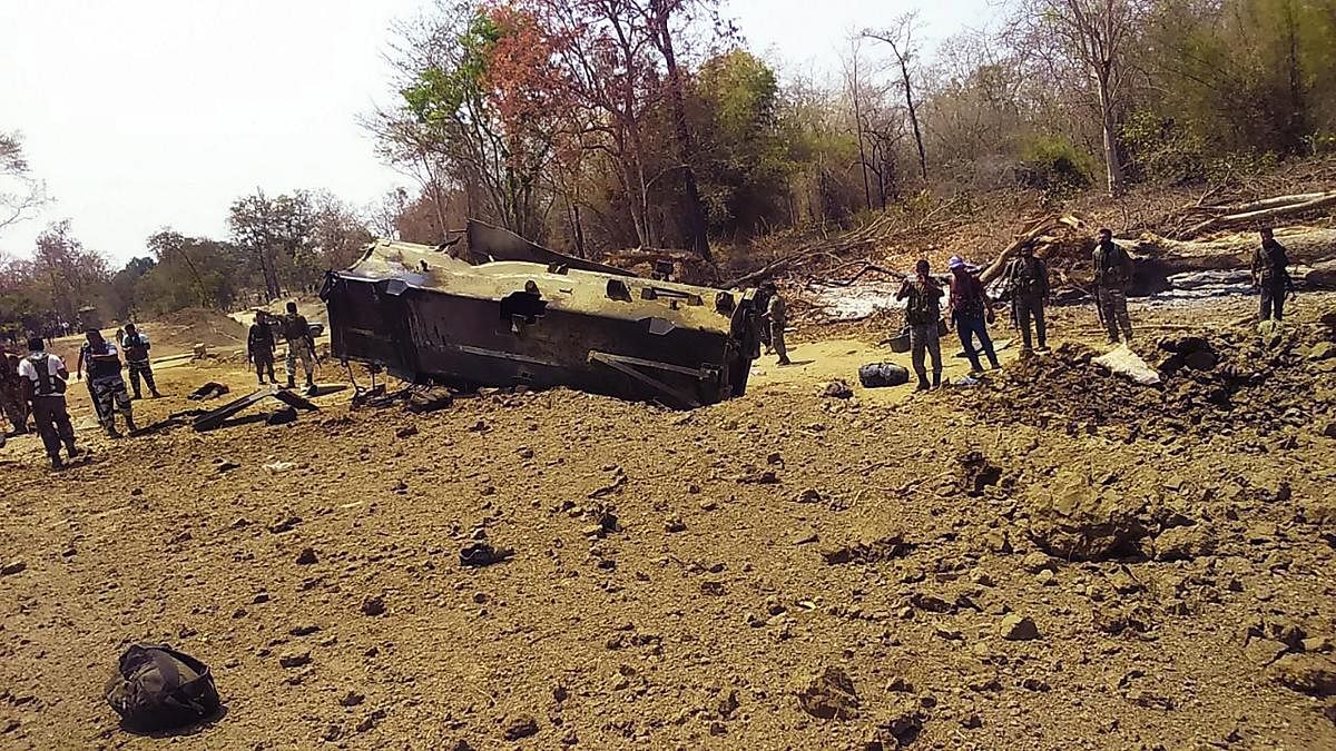 Security personnel inspect the site of an IED blast where nine CRPF personnel were killed and two more were injured after Maoists ambushed them in Kistaram area of Chhattisgarh's Sukma district. PTI