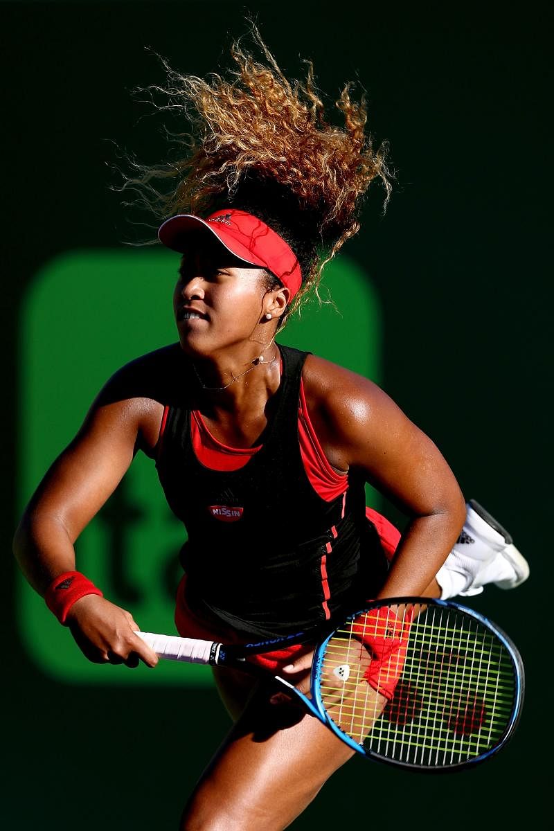 RED HOT Naomi Osaka serves en route to her win over Serena Williams at the Miami Open on Wednesday. AFP