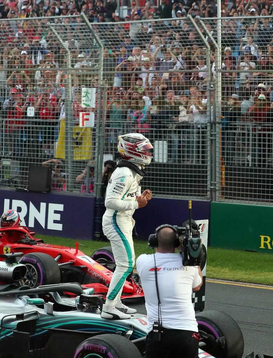SCORCHING RUN Mercedes' Lewis Hamilton celebrates after claiming pole position in the season-opening Australian GP on Saturday. AFP