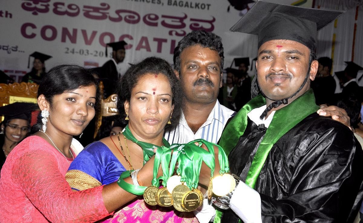 A R Ravikiran celebrates with his parents Rajanna, Gangamma, sister Radha after he was awarded 14 gold medals at the convocation of the University of Horticulture Sciences, Bagalkot, on Saturday. dh photo