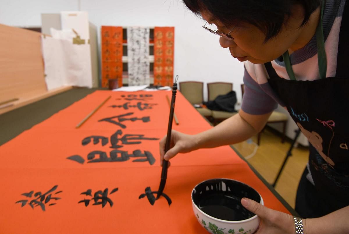 Presidential calligrapher Yang Shu-wan demonstrates her skills in Taipei. AFP