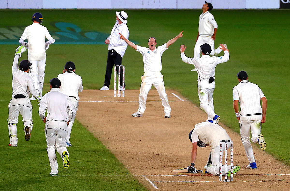 MOMENT OF JOY New Zealand's Todd Astle (centre) celebrates the dismissal of England's final batsman James Anderson in the opening Test on Monday. REUTERS