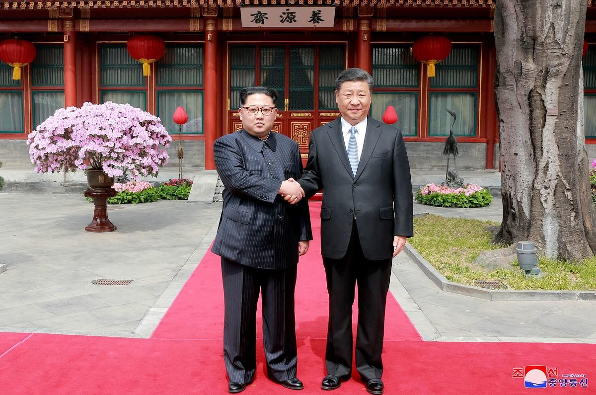 North Korean leader Kim Jong Un (left) shakes hands with Chinese counterpart Xi Jinping at Diaoyutai State Guesthouse in Beijing, China. AP/PTI