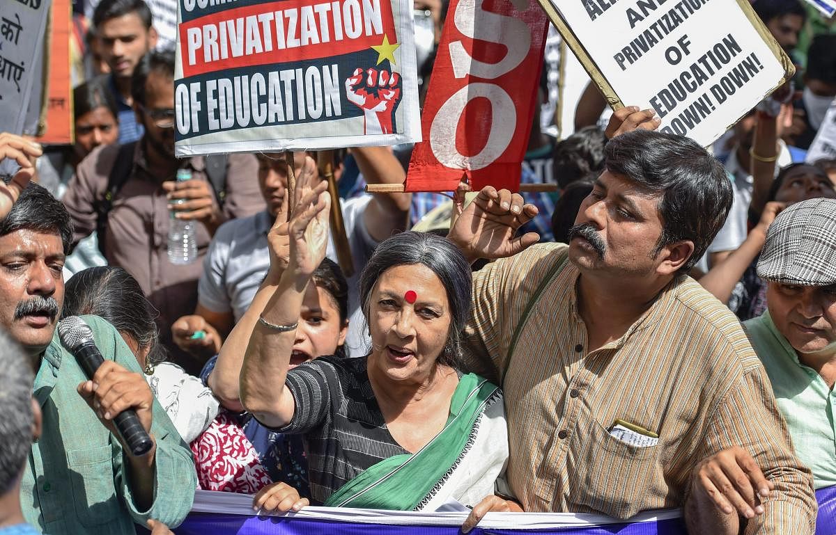 CPI(M) leader Brinda Karat along with members of Delhi University Teachers' Association (DUTA), Federation of Central Universities' Teachers' Associations (FEDCUTA) and other organizations raise slogans during a 'People's March' to protest against Privatisation of universities, in New Delhi on Wednesday. PTI Photo