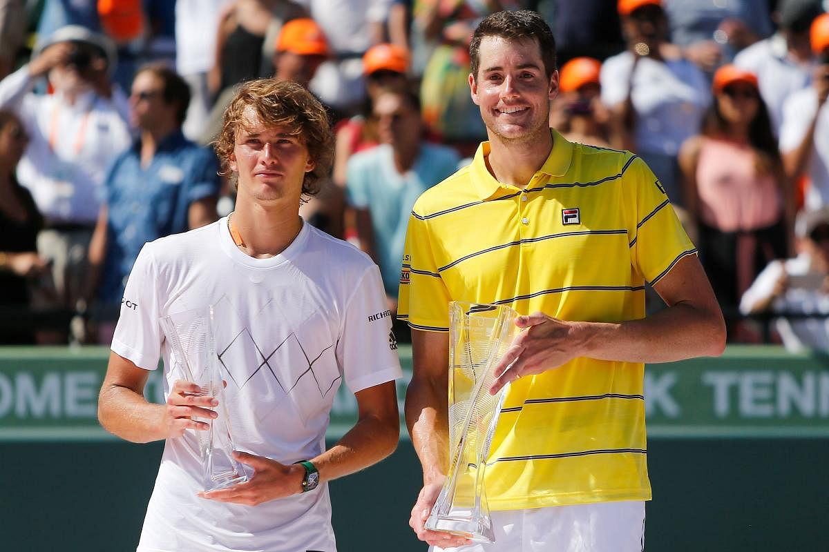 DELIGHT AND DESPAIR Miami Open champion John Isner (right) with runner-up Alexander Zverev of Germany during the trophy ceremony on Sunday. AFP
