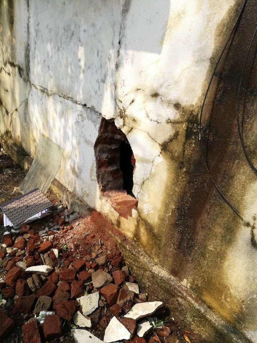 The back wall of the Central Bank of India branch which was drilled by a gang of bank robbers, in Gauribidanur, Chikkaballapur district, on Sunday night. DH Photo.