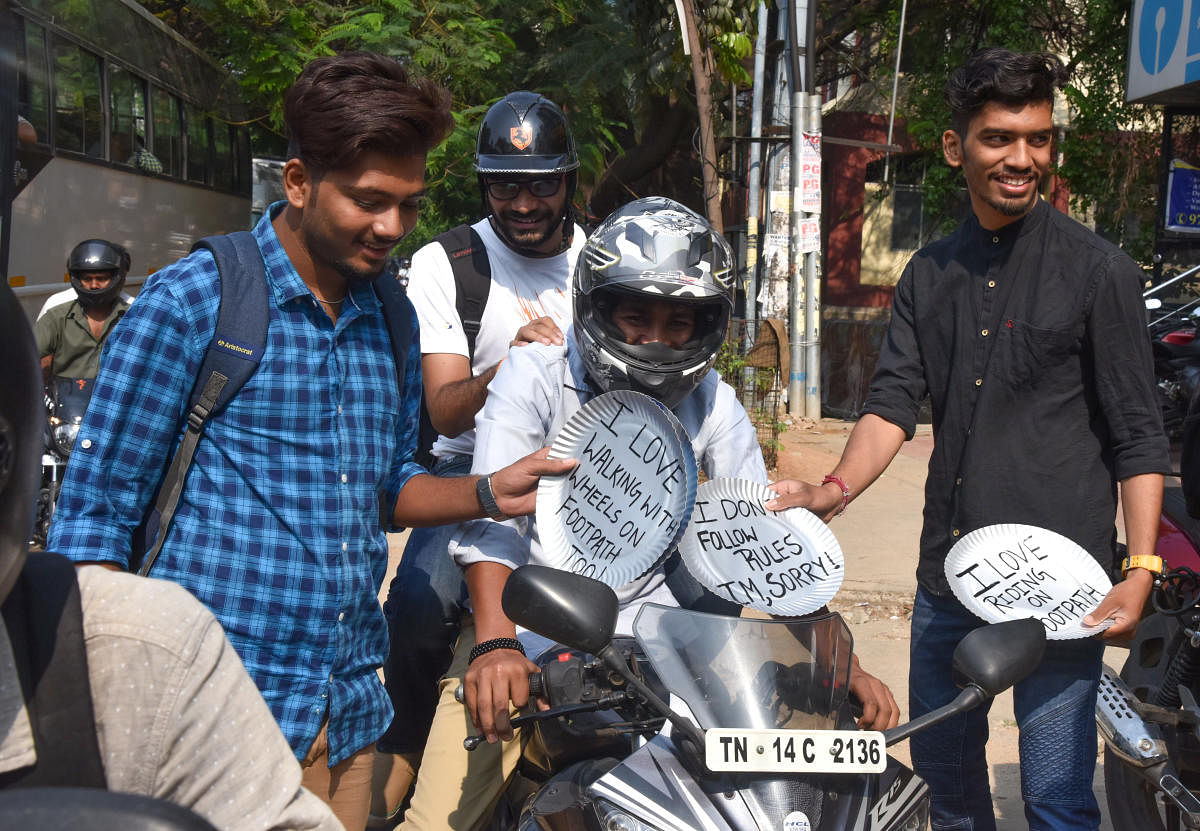 Youth creating awareness campaign against footpath ride, they are giving award to footpath riders and take selfies at Outer Ring road, BTM Layout in Bengaluru on Monday. Photo by S K Dinesh