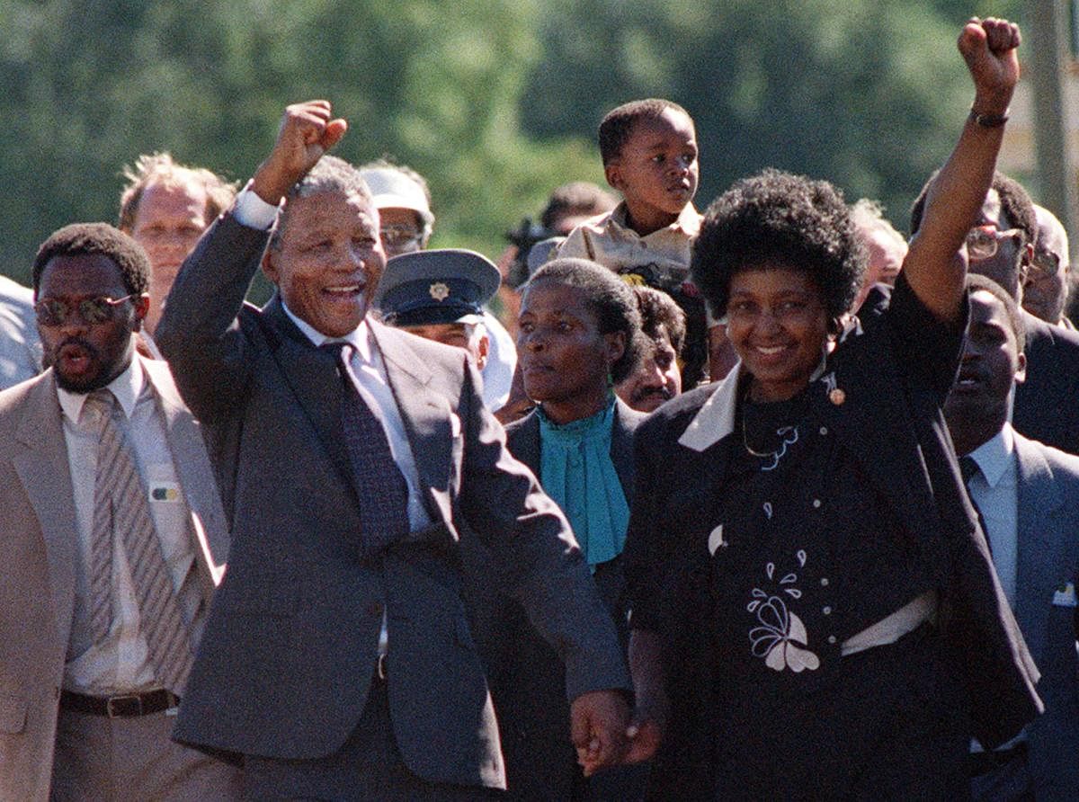 In this file photo taken on February 11, 1990 shows Nelson Mandela (C) and his then-wife Winnie (R) raising their fists and saluting cheering crowd upon Mandela's release from the Victor Verster prison near Paarl. Winnie Mandela, the former wife of South African anti-apartheid fighter and former president Nelson Mandela, died on April 2, 2018 in a Johannesburg hospital after a long illness at the age of 81, her spokesman Victor Dlamini said in a statement. AFP Photo