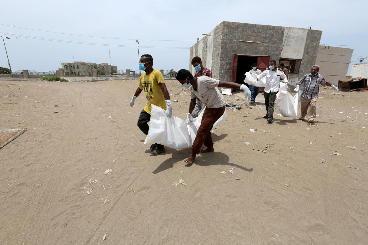 Morgue workers carry plastic bags containing bodies of victims of an airstrike in Hodeida. Reuters file photo