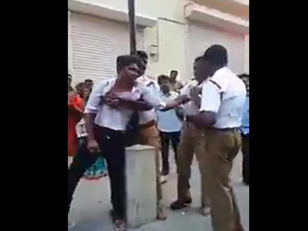 Prakash, 21, who had gone for shopping with his mother and sister in a scooter in the business hub of T Nagar, in the heart of Chennai, was stopped by the policemen for not wearing a helmet. Screen grab/ Twitter
