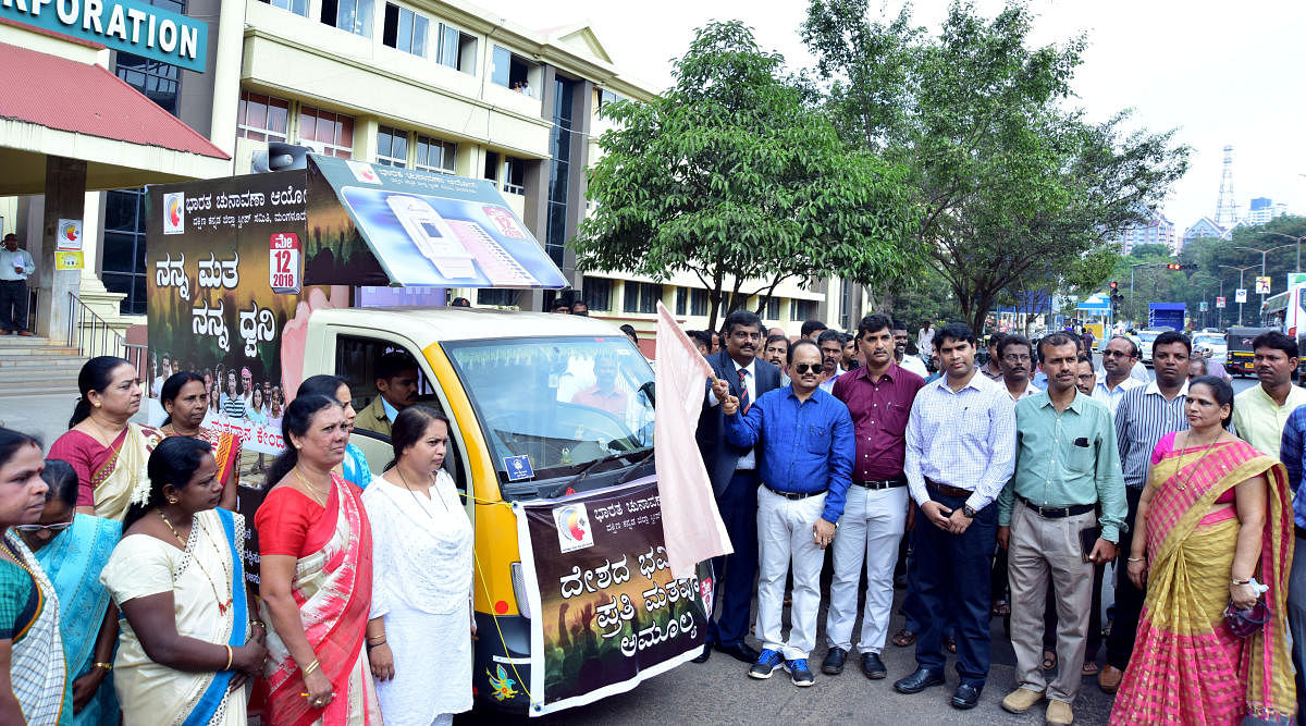 SVEEP Committee Chairman Dr M R Ravi and Principal District and Sessions Judge K S Bilagi flag off mobile voter awareness vehicle in front of MCC office at Lalbagh in Mangaluru on Tuesday.