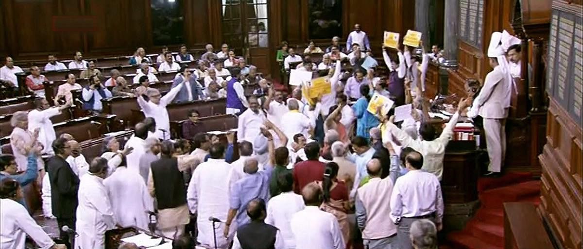 Opposition members protest infront of Rajya Sabha chairperson M Venkaiah Naidu during the ongoing budget session of the Rajya Sabha, at Parliament House in New Delhi on Wednesday. PTI