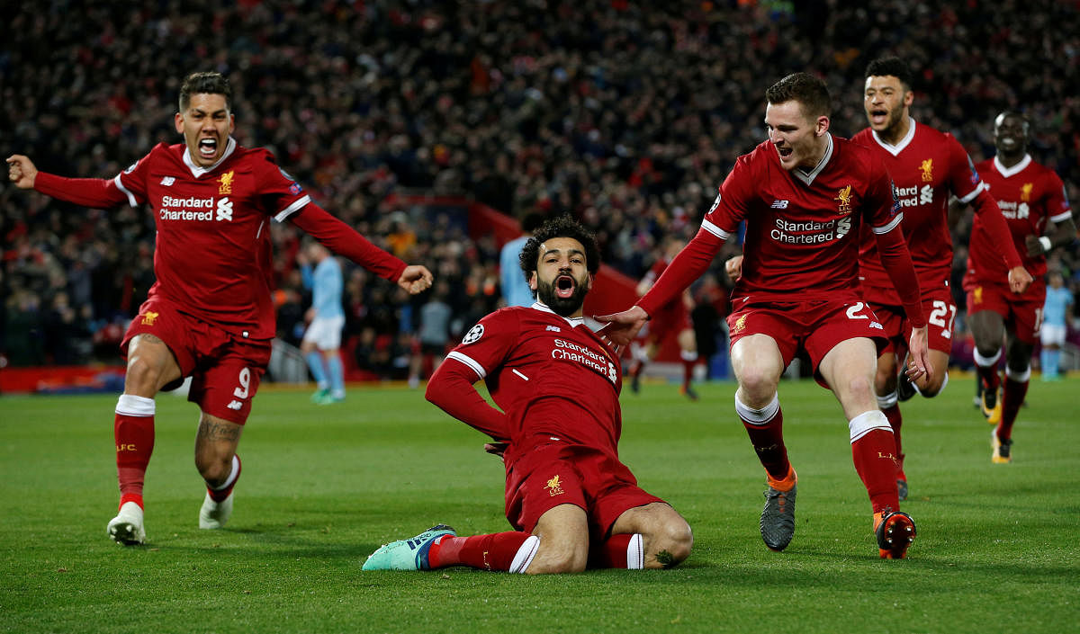 IN SMASHING FORM Liverpool's Mohamed Salah (centre) celebrates with team-mates after scoring the opening goal against Manchester City during their Champions League quarterfinal on Wednesday. REUTERS
