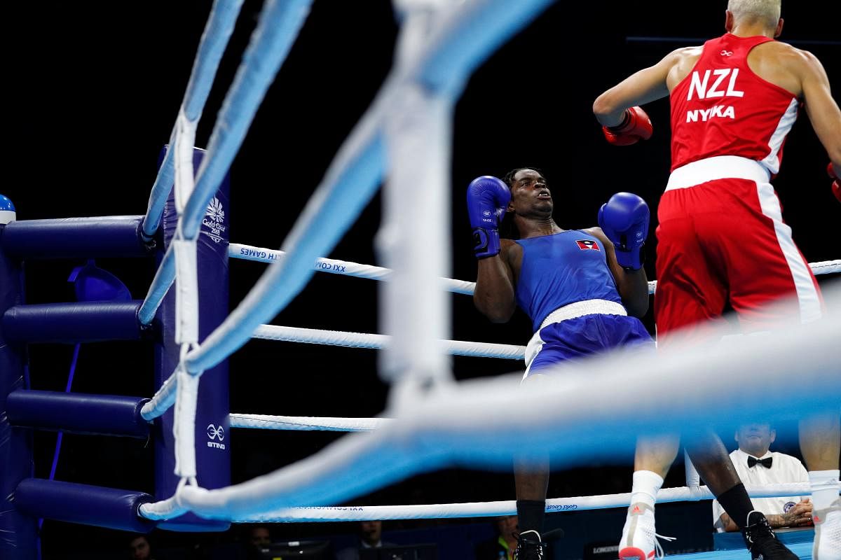 Antigua and Barbuda's Yakita Aska (in blue) fights against New Zealand's David Nyika in the Commonwealth Games boxing on Friday. AFP