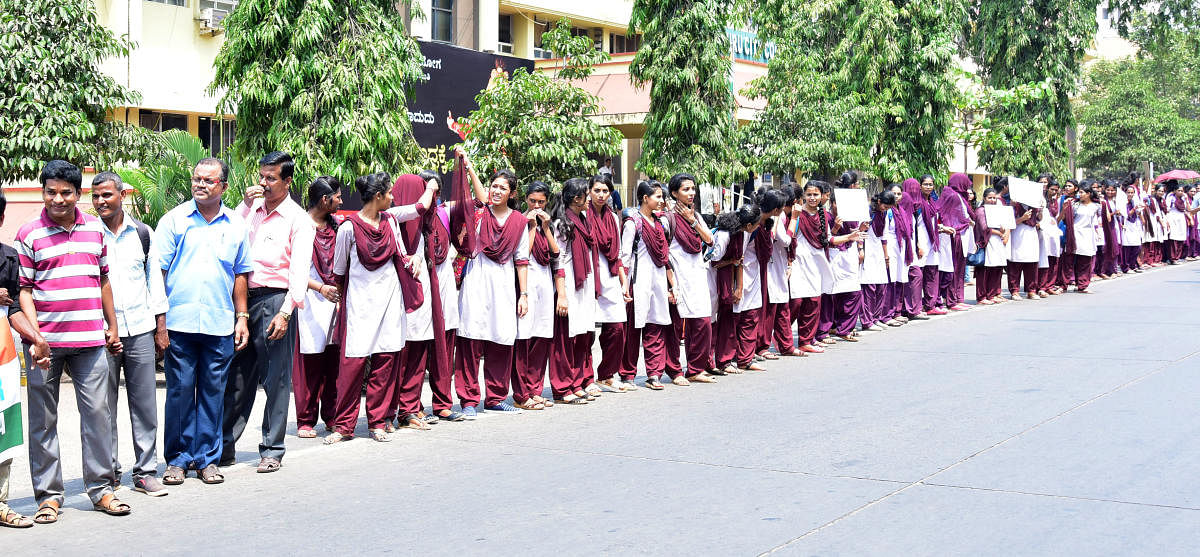 Students form human chain, in front of MCC building in Mangaluru.