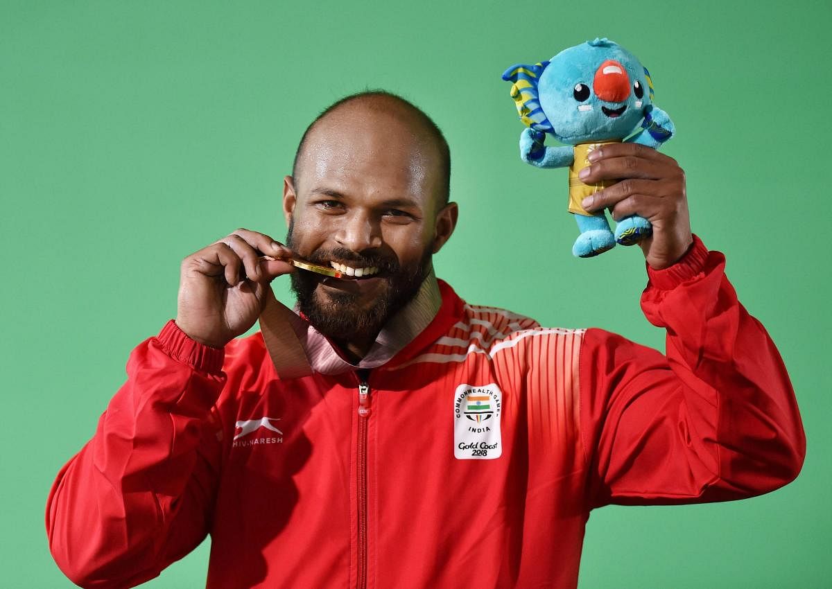 Gold medalist Indian Weightlifter Sathish Kumar Sivalingam during the medal ceremony of the men's 77kg Weightlifting category during the Commonwealth Games 2018 in Gold Coast , on Saturday.