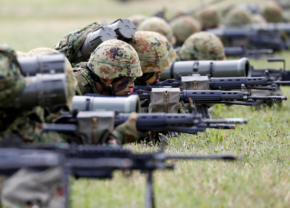 Soldiers of Japanese Ground Self-Defense Force (JGSDF)'s Amphibious Rapid Deployment Brigade, Japan's first marine unit since World War Two, take part in a drill at JGSDF's Camp Ainoura in Sasebo, on the southwest island of Kyushu, on Saturday. REUTERS
