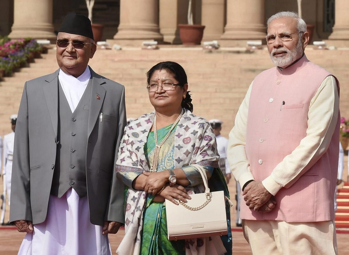 Prime Minister Narendra Modi with his Nepalese counterpart Khadga Prasad Oli as his wife Radhika Shakya looks on during a ceremonial reception at the forecourt of Rashtrapati Bhavan in New Delhi on Saturday. PT
