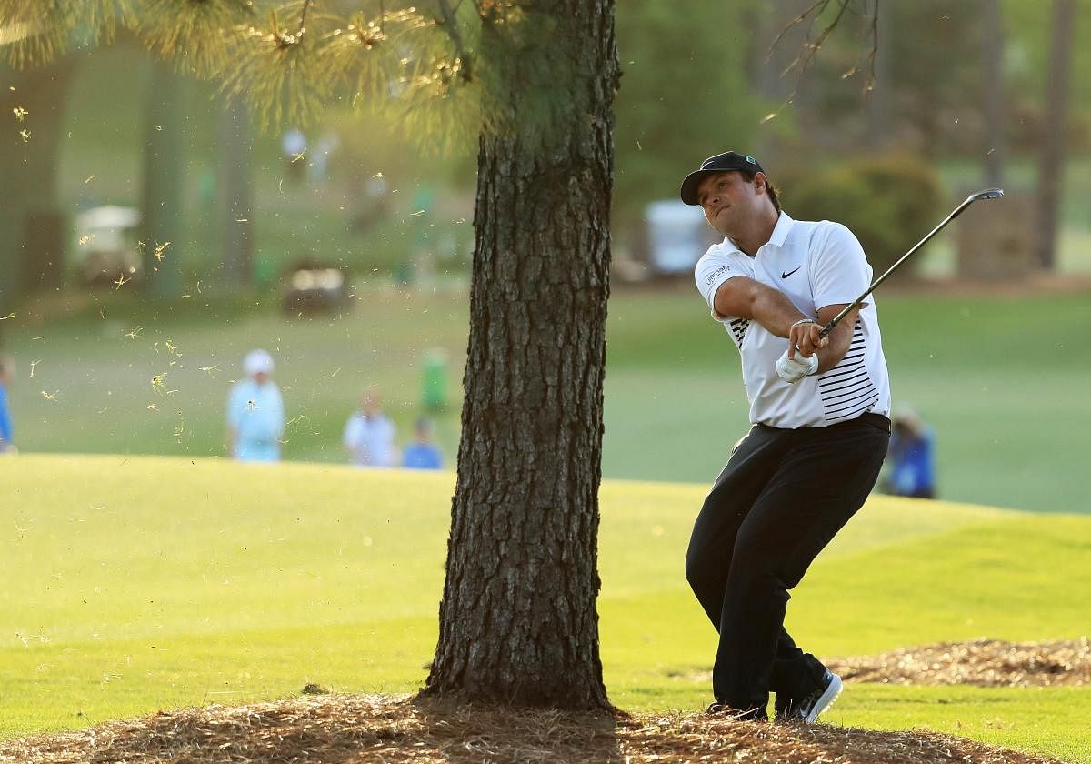 HARD PLAY American Patrick Reed hits from behind the tree during the second round of the Augusta Masters on Friday. AFP