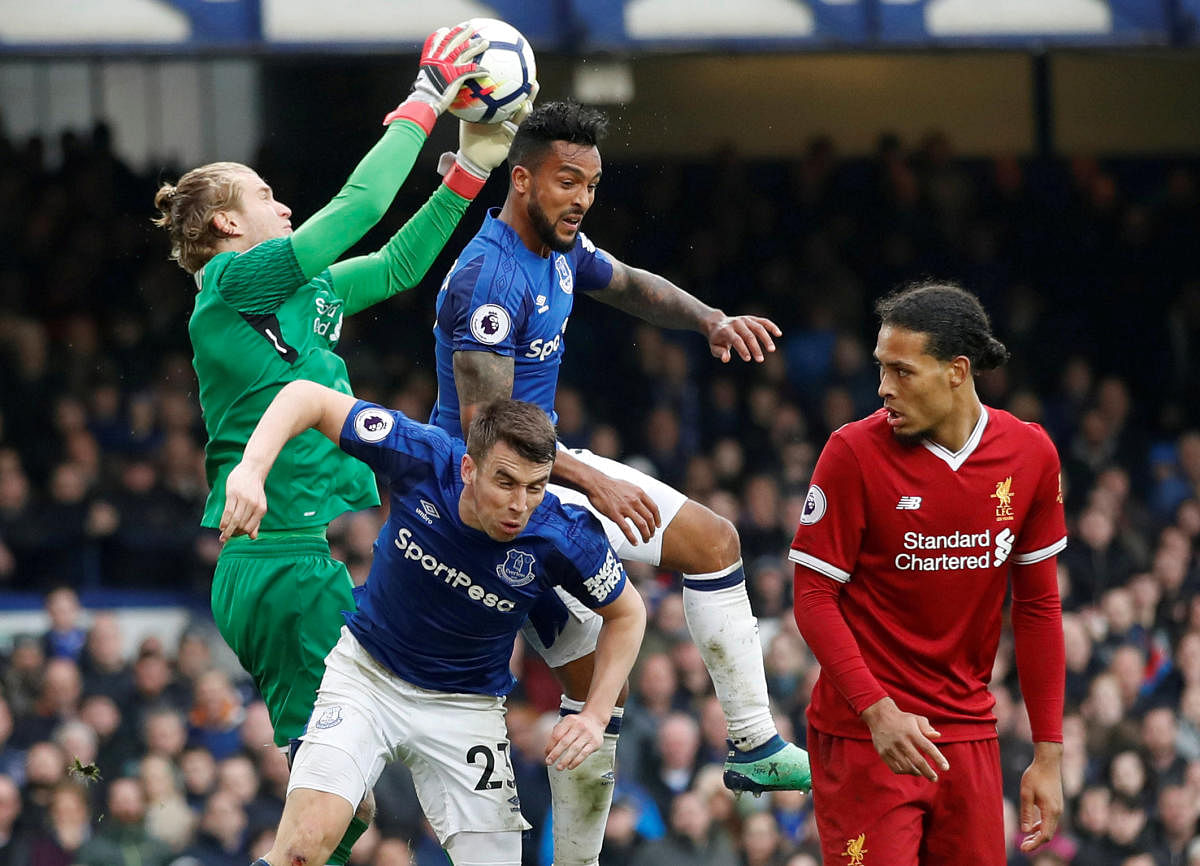 DRAB AFFAIR Liverpool's goalkeeper Loris Karius (left) gathers the ball as Everton's Theo Walcott and Seamus Coleman try in vain to score. REUTERS
