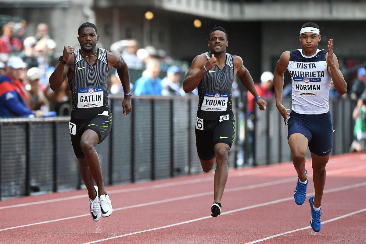 Rising star: Michael Norman (right) runs in the 200M at the US trials along with Justin Gatlin (left) and Isiah Young. File Photo