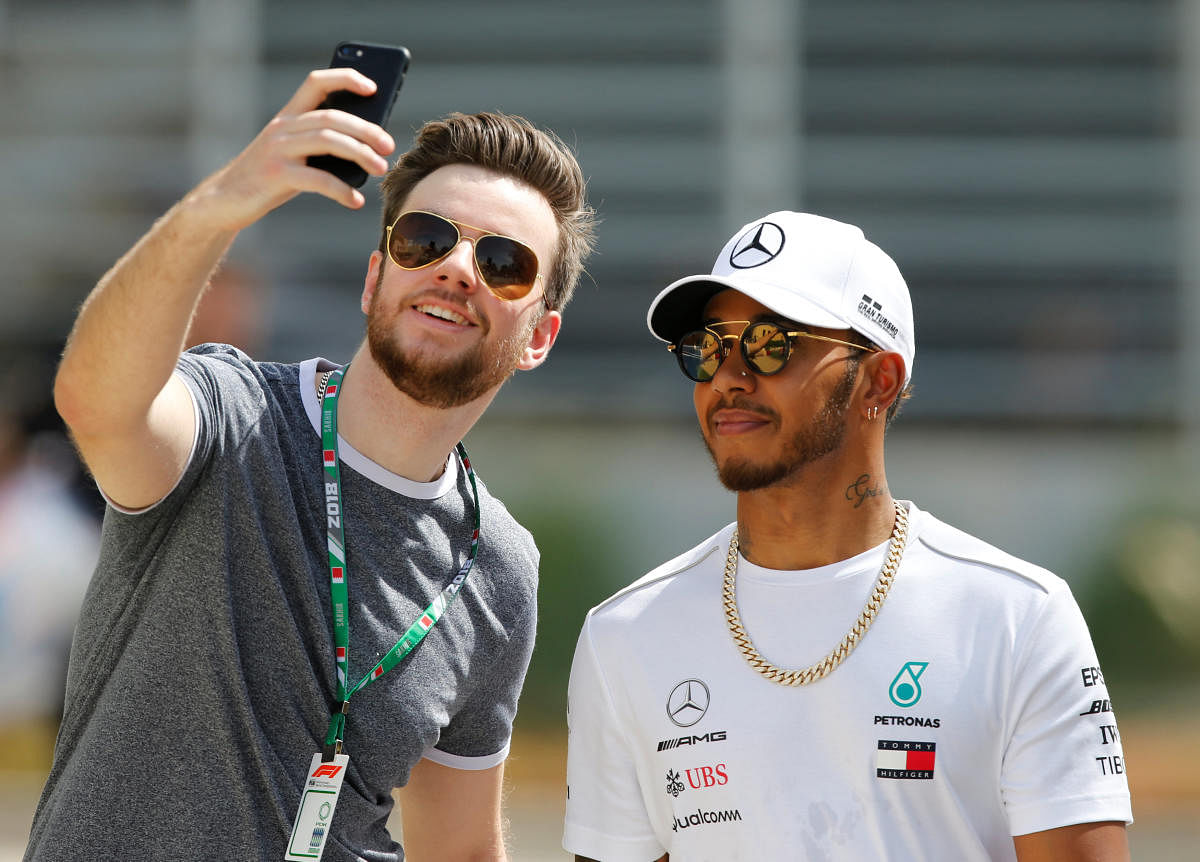 FAN FAVOURITE Mercedes' Lewis Hamilton poses for a selfie with a fan ahead of the Bahrain GP qualifying on Saturday. REUTERS