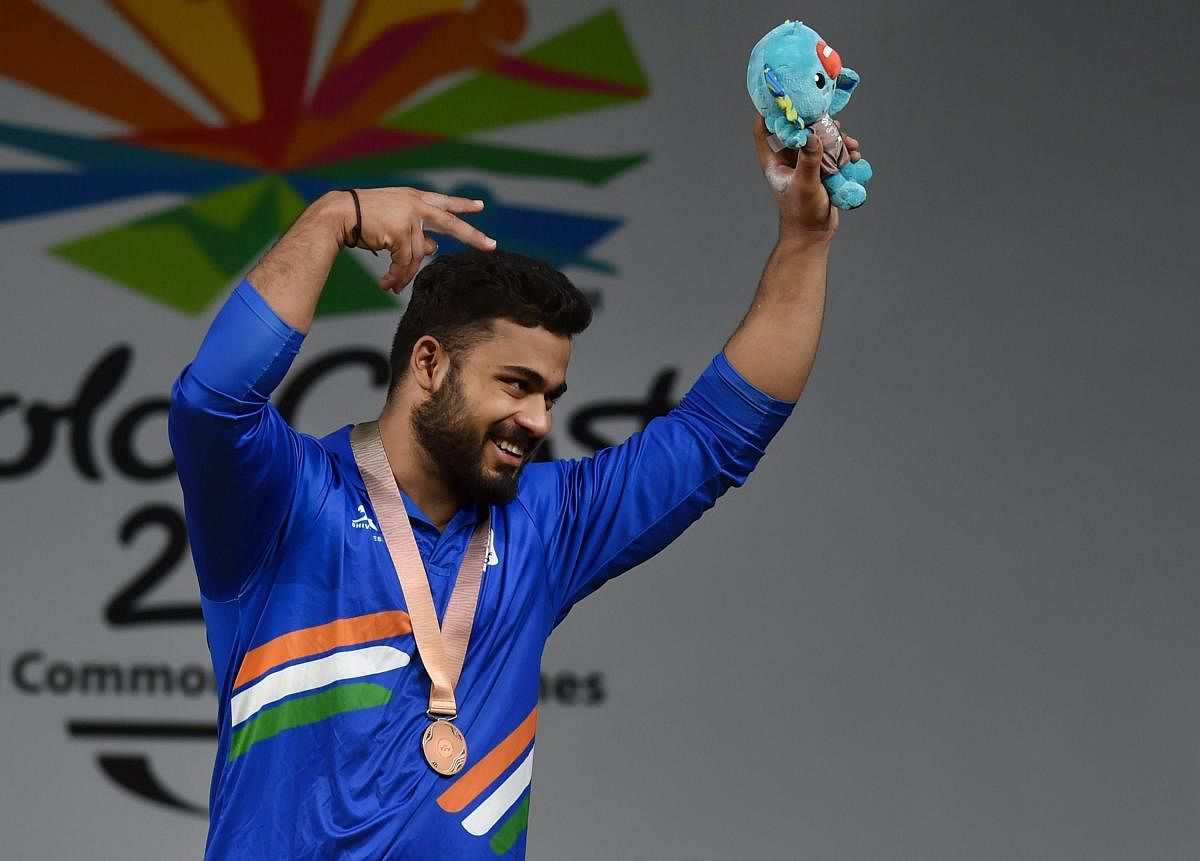 BRAVE EFFORT India's Vikas Thakur celebrates with his bronze medal that he won in the men's 94kg category weightlifting at the Commonwealth Games in Gold Coast on Sunday. PTI