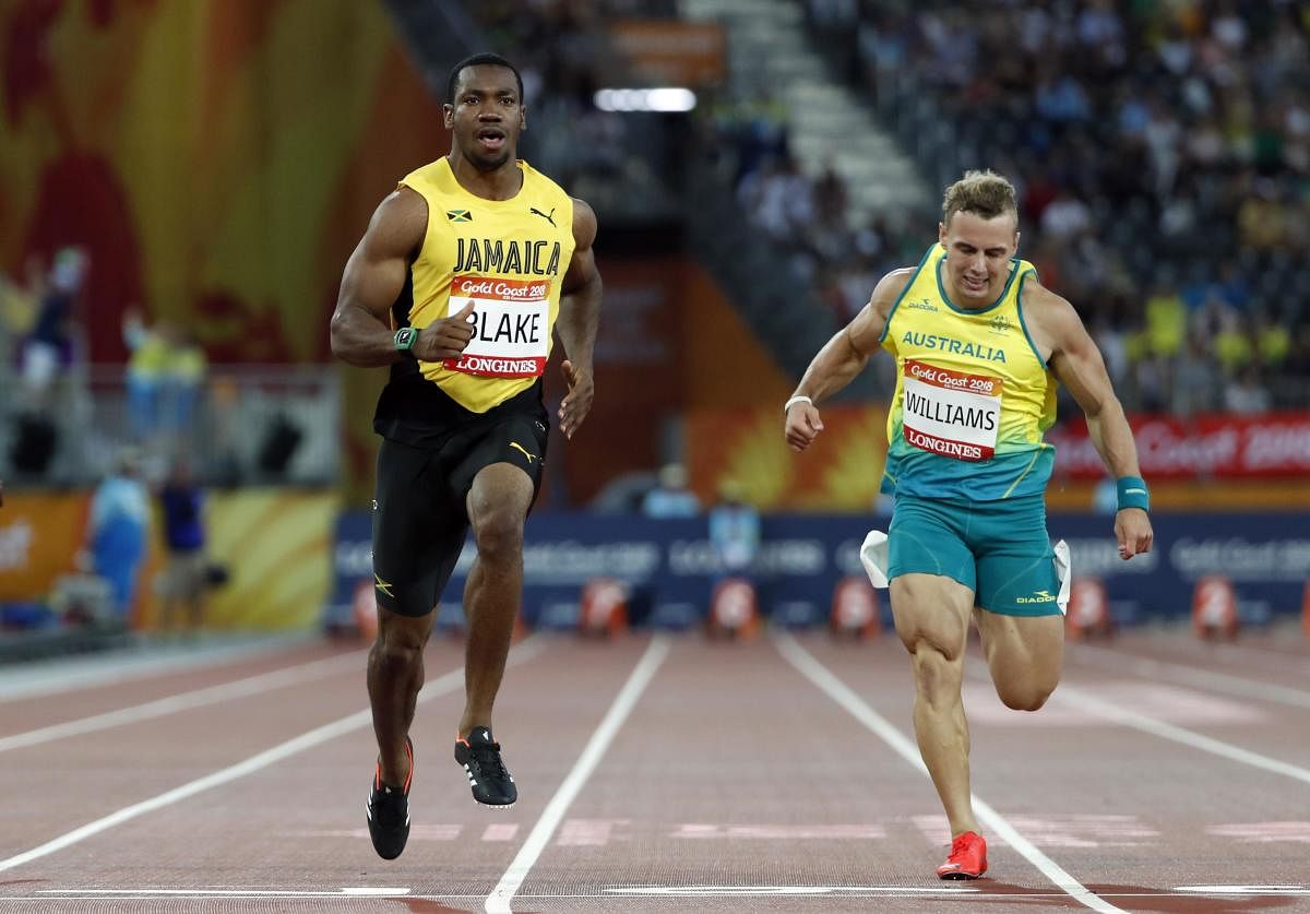 RED-HOT FAVOURITE Jamaica's Yohan Blake (left) coasts to victory in the 100M semifinals at the Carrara Stadium on Sunday. REUTERS