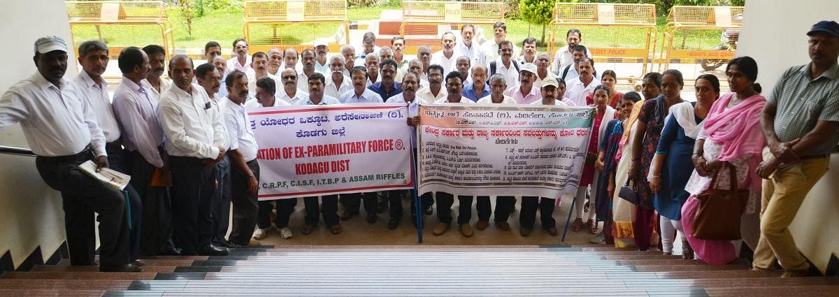 Ex-servicemen Association and former paramilitary personnel stage a protest in front of Gandhi Mantapa in Madikeri on Friday, urging for the fulfillment of various demands.