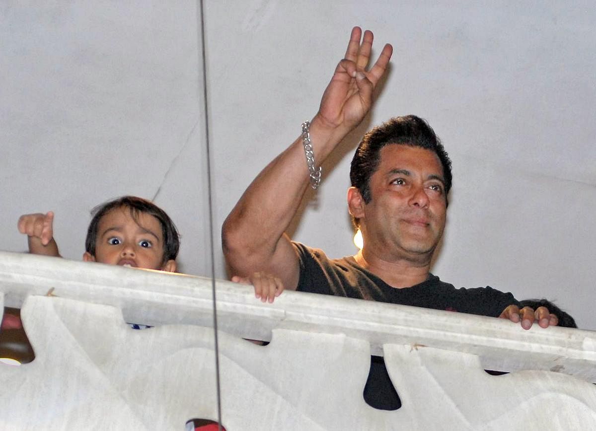 Bollywood actor Salman Khan (R) acknowledges his fans as he arrives at his house after he was granted bail in the 1998 Black Buck poaching case in which he was earlier sentenced to five years in jail, in Mumbai on Saturday. PTI Photo