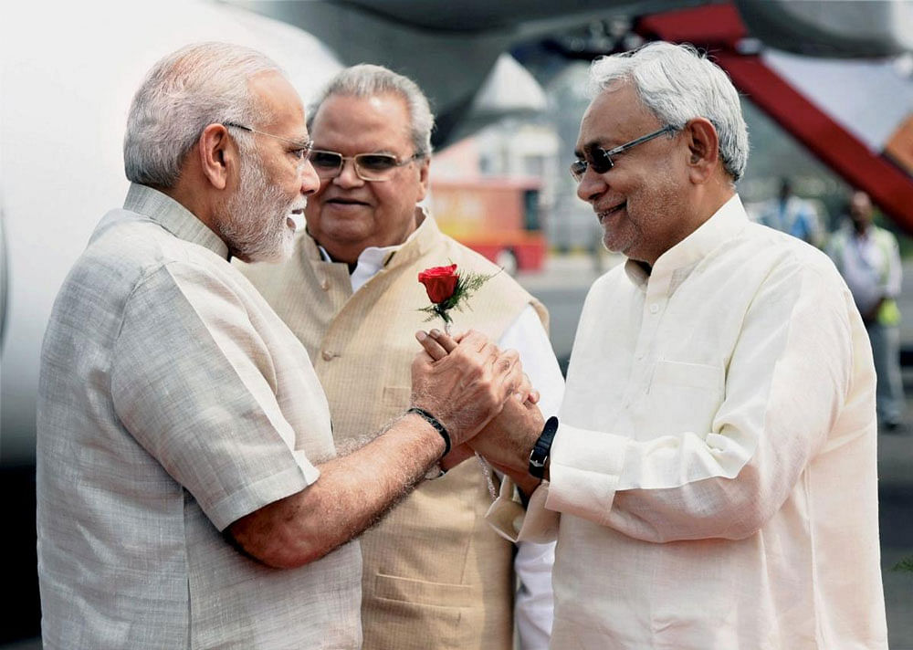 Prime Minister Narendra Modi being welcomed by Bihar Chief Minister Nitish Kumar and Bihar Governor Satyapal Malik upon his arrival at Jay Prakash Narayan International Airport in Patna. PTI/PIB photo.