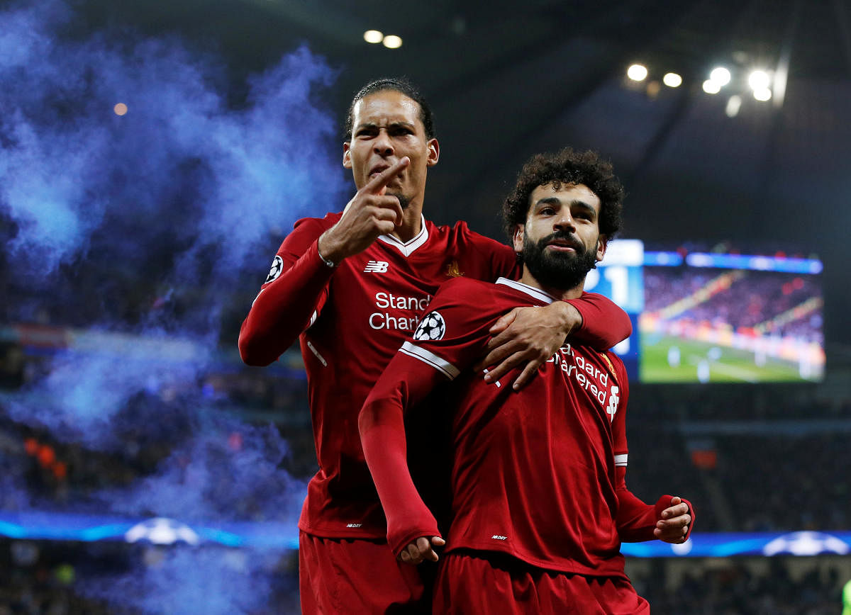KILLER BLOW Liverpool's Mohamed Salah (right) celebrates with Virgil van Dijk after scoring his side's first goal against Manchester City on Tuesday. REUTERS