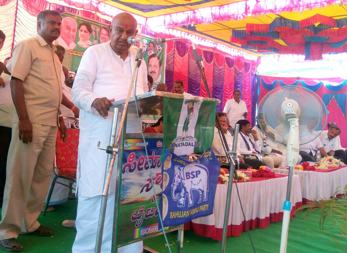 JD(S) supremo H D Deve Gowda addresses a meeting, in Holenarasipur, Hassan district on Wednesday.