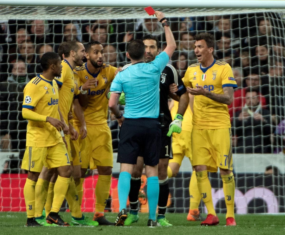 English referee Michael Oliver shows the red card to Juventus' goalkeeper Gianluigi Buffon (second from right). AFP