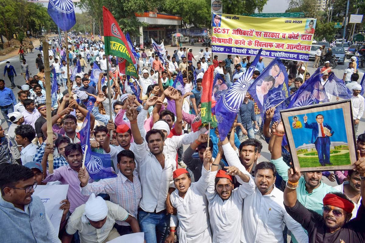 Bhim Sena and Samajwadi Party supporters raise slogans during 'Bharat Bandh' call by Dalit organisations against the alleged 'dilution' of Scheduled Castes/Scheduled Tribes act, in Moradabad on Monday. PTI Photo