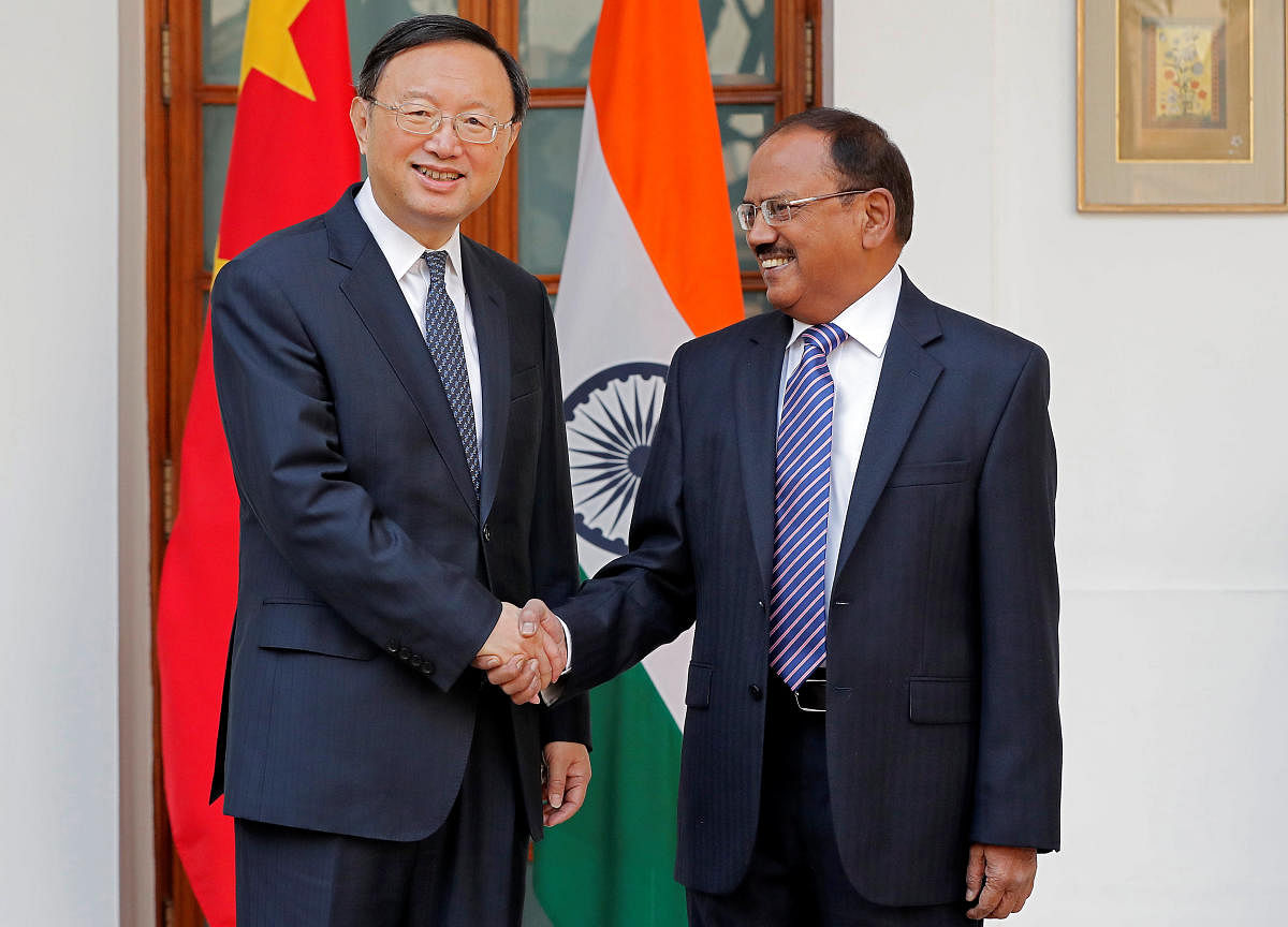 China's State Councilor Yang Jiechi (L) and India's National Security Advisor Ajit Doval shake hands during a photo opportunity before their meeting in New Delhi, India, December 22, 2017.