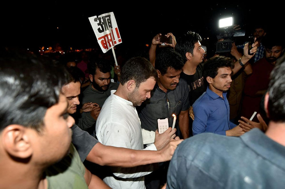 Congress President Rahul Gandhi takes part in a candlelight vigil at India Gate to protest against the growing incidents of violence against the girl child and women, in New Delhi on Thursday late night. PTI.